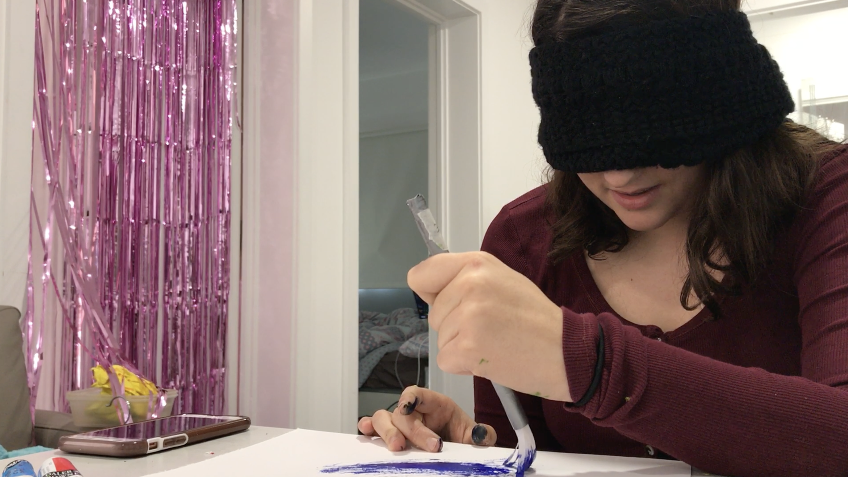 Woman painting blindfolded