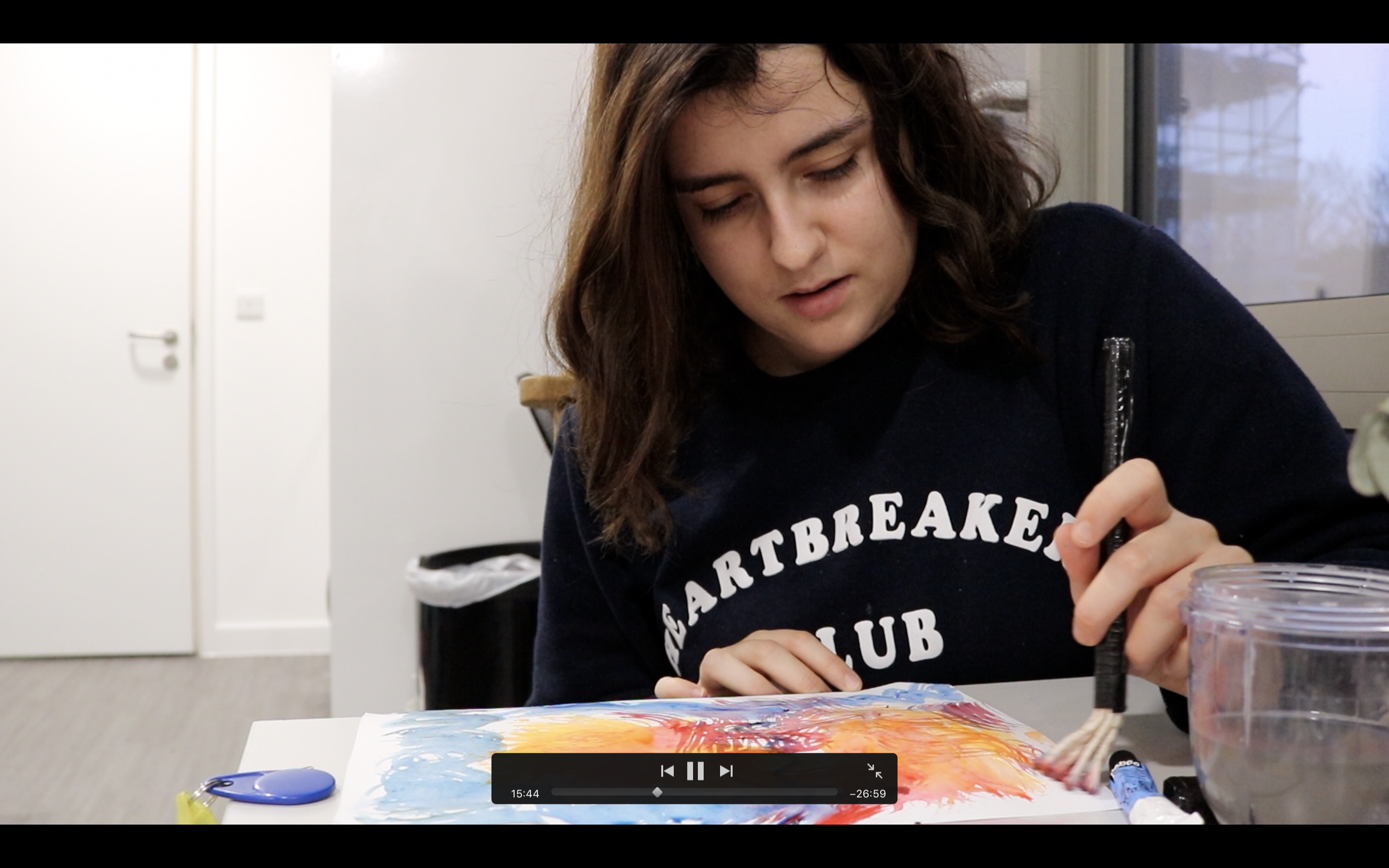 Woman painting with DIY brush