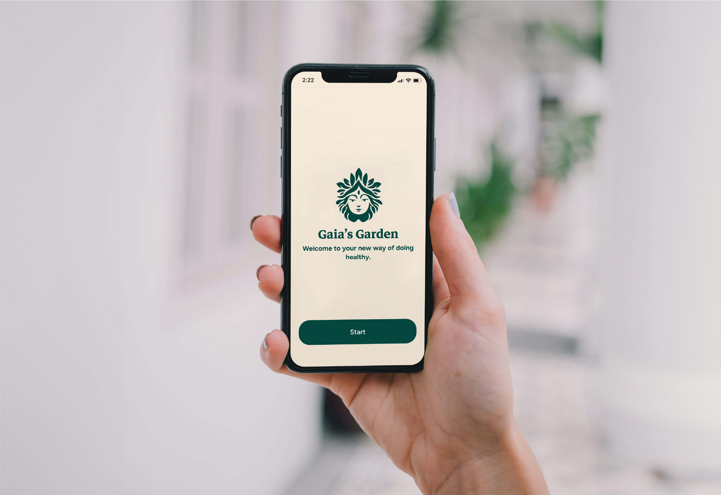 Hand holding a prototype of Gaia's Garden login screen